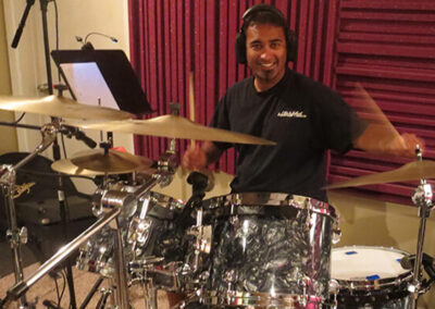 Professional drummer performing during a studio recording session