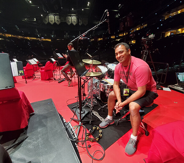 Neel Shukla performing percussion during a studio recording session