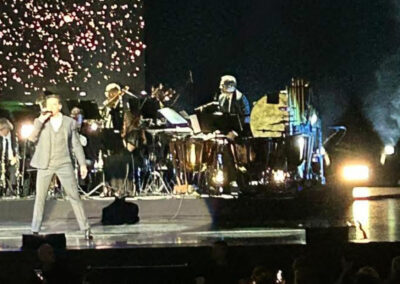 Band performing live on stage with lighting and instruments