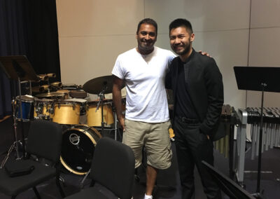 Musicians posing together backstage at a music event