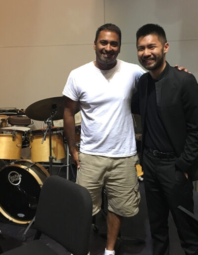 Musicians posing together backstage at a music event