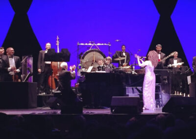 Orchestra and singers performing live on stage