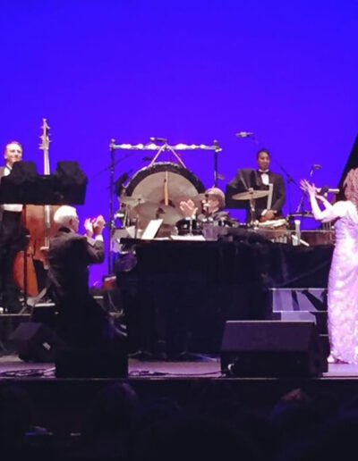 Orchestra and singers performing live on stage