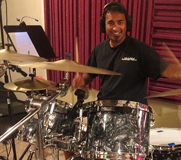 Neel Shukla performing percussion during a studio recording session